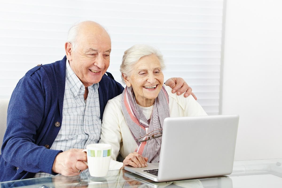 Elderly couple using the internet to learn about home care options